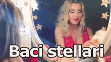 a woman in a red dress is looking in a mirror with the words baci stellari