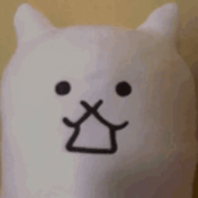 a close up of a stuffed animal with a smiley face on its face .