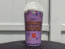 a mcdonald 's drink that says celebrate crimaces birthday