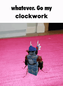 a picture of a robot on a pink rug with the caption whatever go my clockwork
