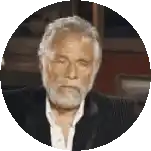 a man with a beard is wearing a suit and a white shirt .