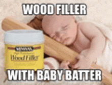 a baby is sleeping next to a can of wood filler and a rolling pin .