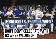 a group of baseball players sitting in a dugout with a banner that says mlb network