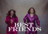 two women in purple jumpsuits are dancing in front of the words `` best friends '' .