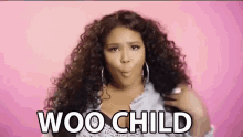 a woman with curly hair is making a funny face and says woo child .