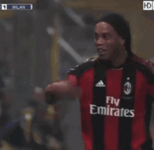 a soccer player wearing a fly emirates shirt