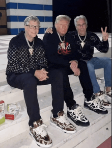 three men are posing for a picture and one of them has a gucci sweater on