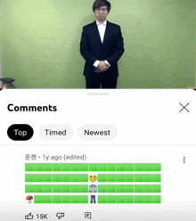 a man in a suit is standing in front of a green wall with the words comments on the bottom