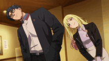 a man and a woman are standing next to each other and the man has a pin on his jacket that says o