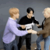 a group of young men are standing next to each other holding hands while a man holds a toy horse .