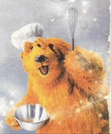 a bear wearing a chef 's hat is holding a bowl and whisk