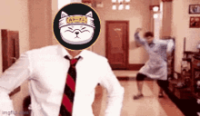 a man in a white shirt and red tie is dancing with a cat on his head