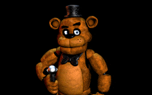 a brown teddy bear with a top hat and bow tie holding a microphone