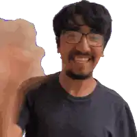 a man with glasses and a beard smiles for the camera