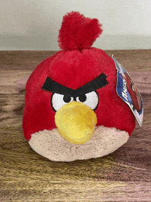 a red angry bird stuffed animal with a tag attached to it