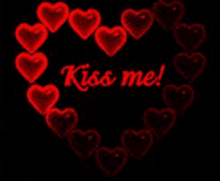 a heart made of red hearts with the words kiss me written on it