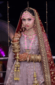 a woman in a bride 's dress is wearing many bracelets