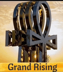 a poster for grand rising with a statue of ankh