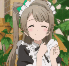 a girl in a maid outfit is smiling and holding her hands together