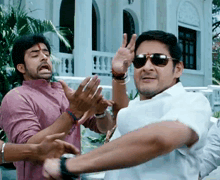 a man wearing sunglasses is making a peace sign with his hands