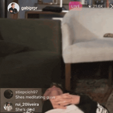 a screenshot of a live stream shows a man laying on the floor with a caption that says she 's meditating guys