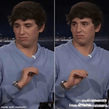 a man in a blue shirt is making a face