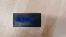 a blue object is sitting on a black surface