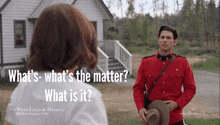 a man in a red uniform stands in front of a white house with the words what 's what 's the matter