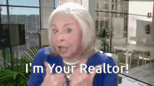 a woman says " i 'm your realtor " in front of a window