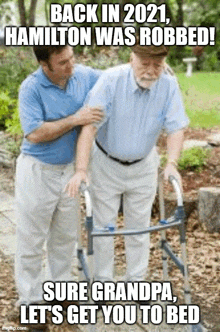 a man helping an elderly man with a walker with a caption that says " back in 2021 hamilton was robbed "