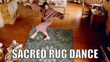 a man in a robe is dancing on a rug with the words sacred rug dance written below him