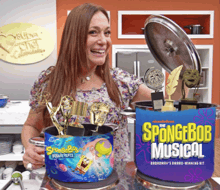 a woman holding a pot of spongebob musical awards