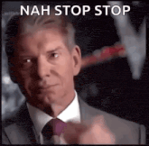 a man in a suit and tie is pointing at the camera with the words nah stop stop below him