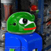 a green and blue toy with the words smg muggleg coin on the bottom right