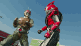 a man in a masked rider costume is fighting another man in a green jumpsuit