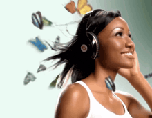 a woman wearing beats headphones with butterflies flying around her head