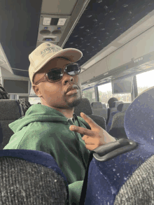 a man on a bus wearing a hat that says arizona