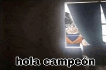 a person is looking out of a window with the words `` hola campeon '' written on it .