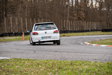 a white car with a license plate that says 00-598-tm