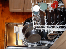 a dishwasher with a red nescafe mug on top