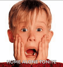 a young boy is making a surprised face with his hands on his face and the words `` home alone tonite '' written below him .