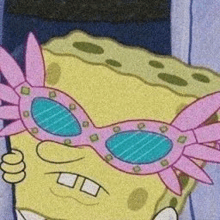 spongebob squarepants is wearing a pair of pink glasses .