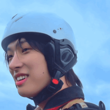 a close up of a person wearing a helmet with a red button