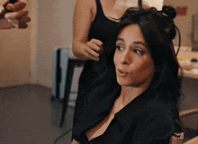 a woman getting her hair done by a hairdresser