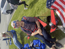 an elderly woman sits in a red chair with a can of coca cola in her hand