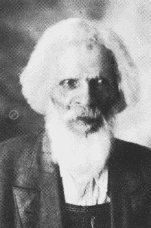 a black and white photo of a man with a beard and long hair