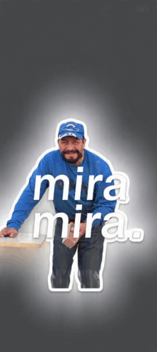 a man in a blue shirt and hat is standing next to a sign that says mira mira