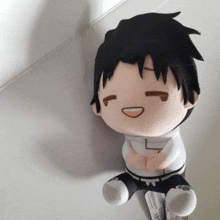 a stuffed toy with a tag that says ' tokyo ghoul ' on it sits on a white surface