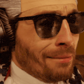 a close up of a man wearing sunglasses and a fake head