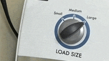 a close up of a washing machine 's load size knob .